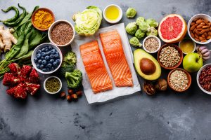 Healthy food: fish, fruit, vegetable, seeds, superfood, leaf vegetable